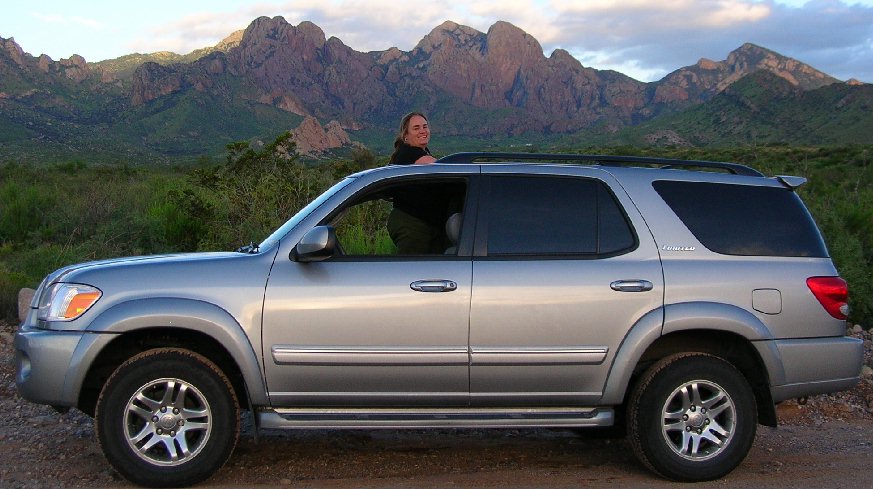 Cathy and her
                  new car - Organ Mountains in background.
